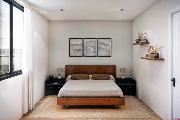 a bedroom with a bed and wall painting