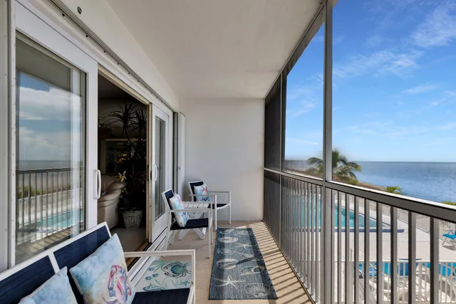 a spacious bedroom with a bed and a chandelier
