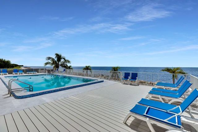 a view of a swimming pool with lawn chairs