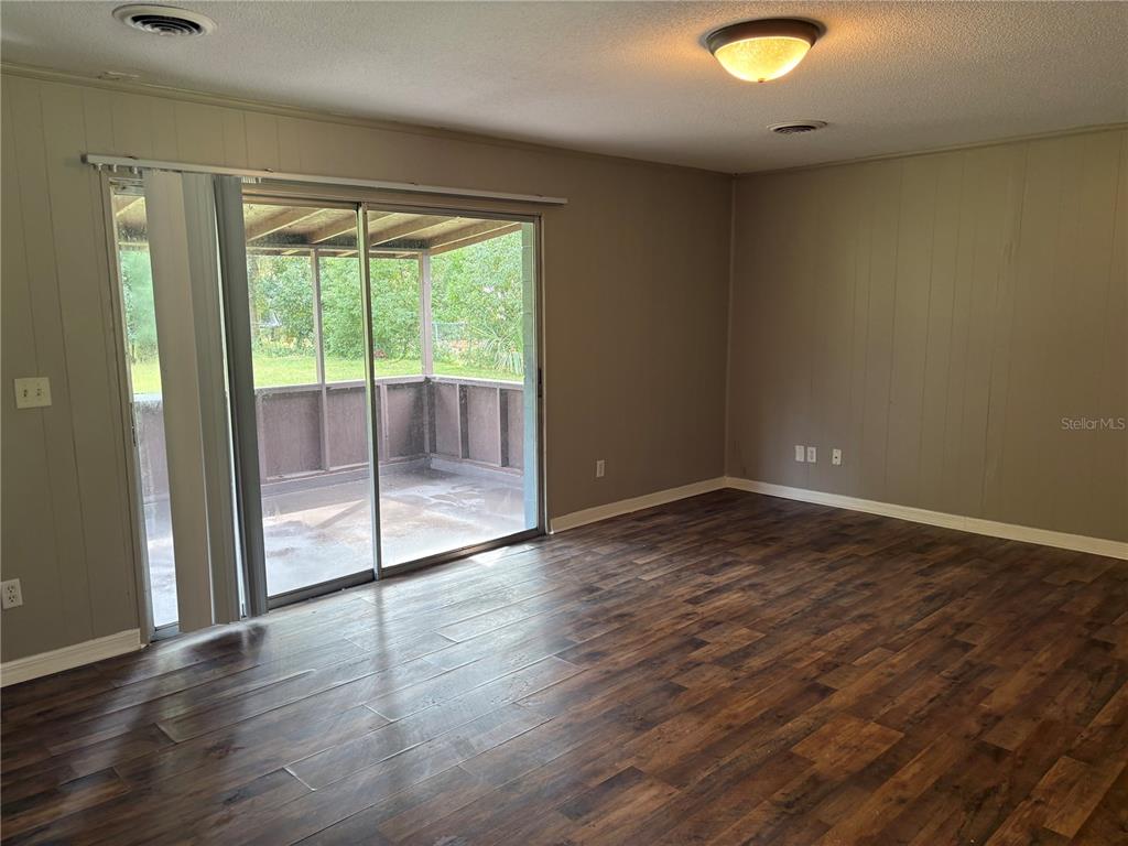 1236 Northeast 22nd Street Ocala, FL 34470 - Photo 20 of 42 a view of empty room with wooden floor and fan