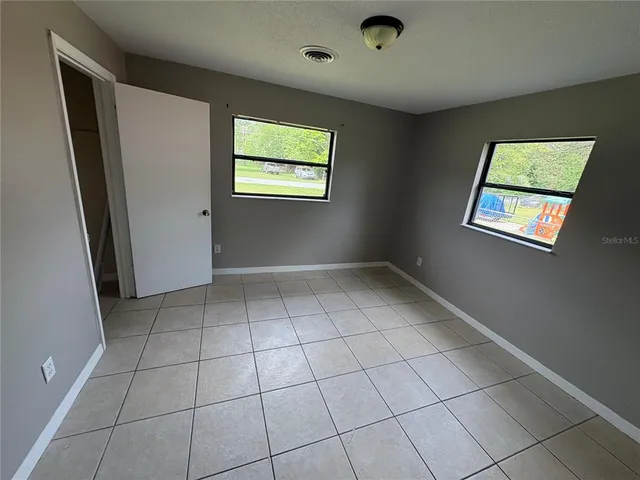 an empty room with wooden floor