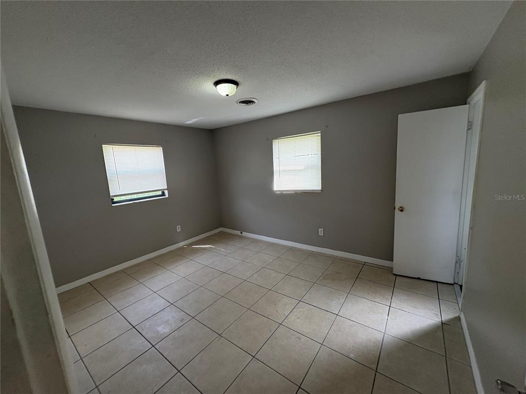 1236 Northeast 22nd Street Ocala, FL 34470 - Photo 25 of 42 an empty room with windows