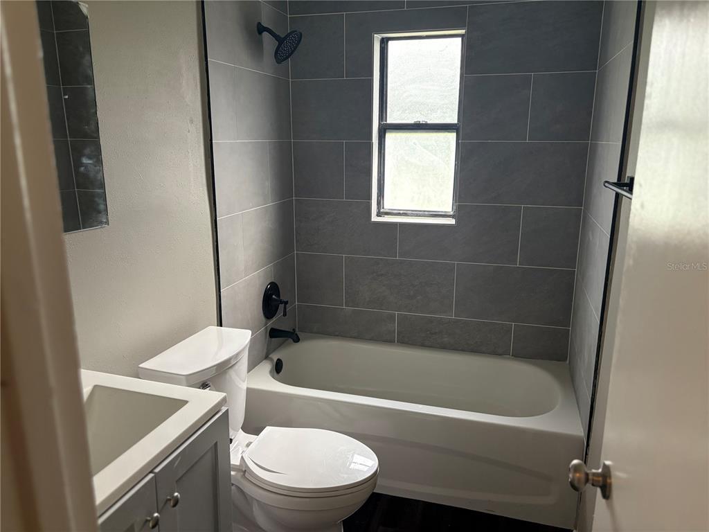 1236 Northeast 22nd Street Ocala, FL 34470 - Photo 28 of 42 a bathroom with a sink a toilet and bathtub