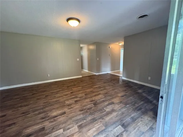 a view of room with wooden floor