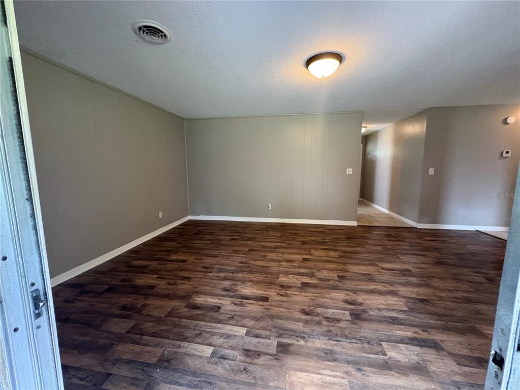 1236 Northeast 22nd Street Ocala, FL 34470 - Photo 35 of 42 a view of room with wooden floor