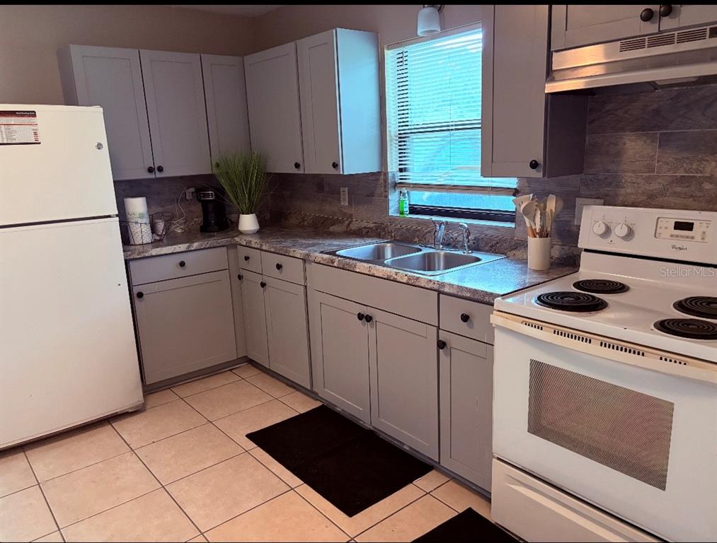 1236 Northeast 22nd Street Ocala, FL 34470 - Photo 37 of 42 a kitchen with a sink stove and cabinets