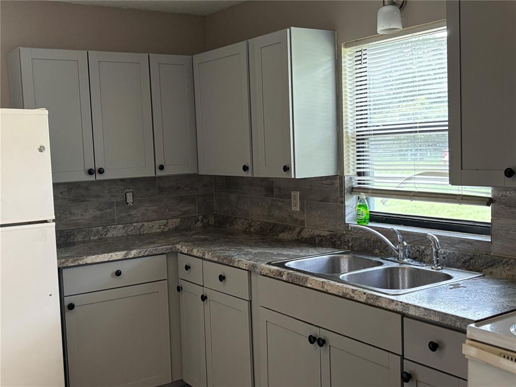 1236 Northeast 22nd Street Ocala, FL 34470 - Photo 38 of 42 a kitchen with a sink cabinets and window