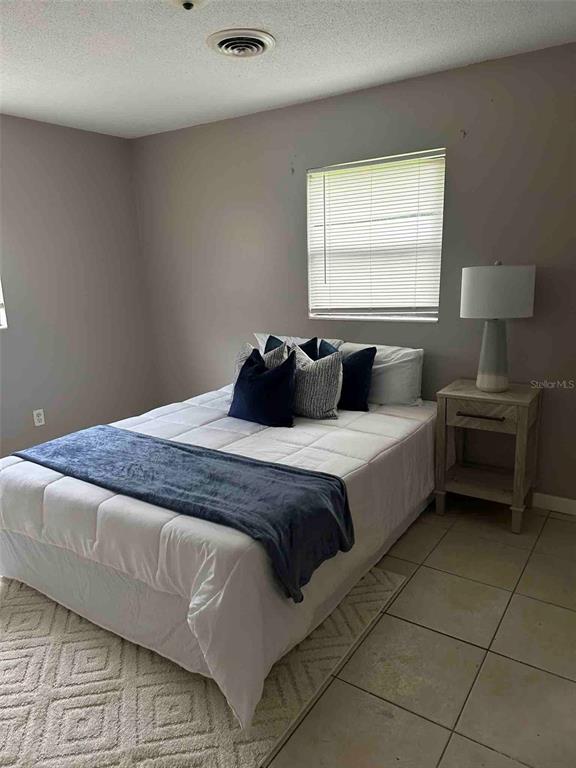 1236 Northeast 22nd Street Ocala, FL 34470 - Photo 41 of 42 a bedroom with a bed and a window