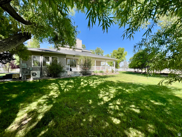 812 East Bates Cyn Road Tooele, UT 84074 - Photo 92 of 144 Expansive rear yard featuring a manicured lawn and mature trees