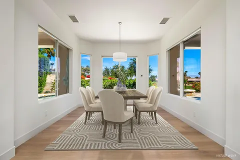 a large kitchen with kitchen island a sink table and chairs