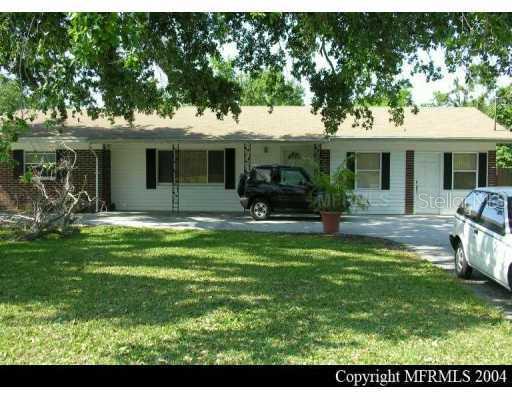 1650 Neptune Road Kissimmee, FL 34744 - Photo 1 of 1 a backyard of a house with table and chairs