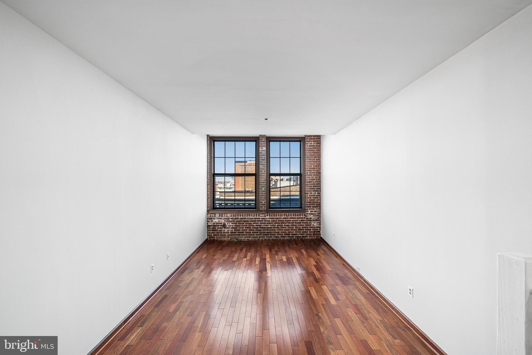 315 New Street, Unit 614 Philadelphia, PA 19106 - Photo 13 of 34 Living room w/ exposed brick and oversized windows