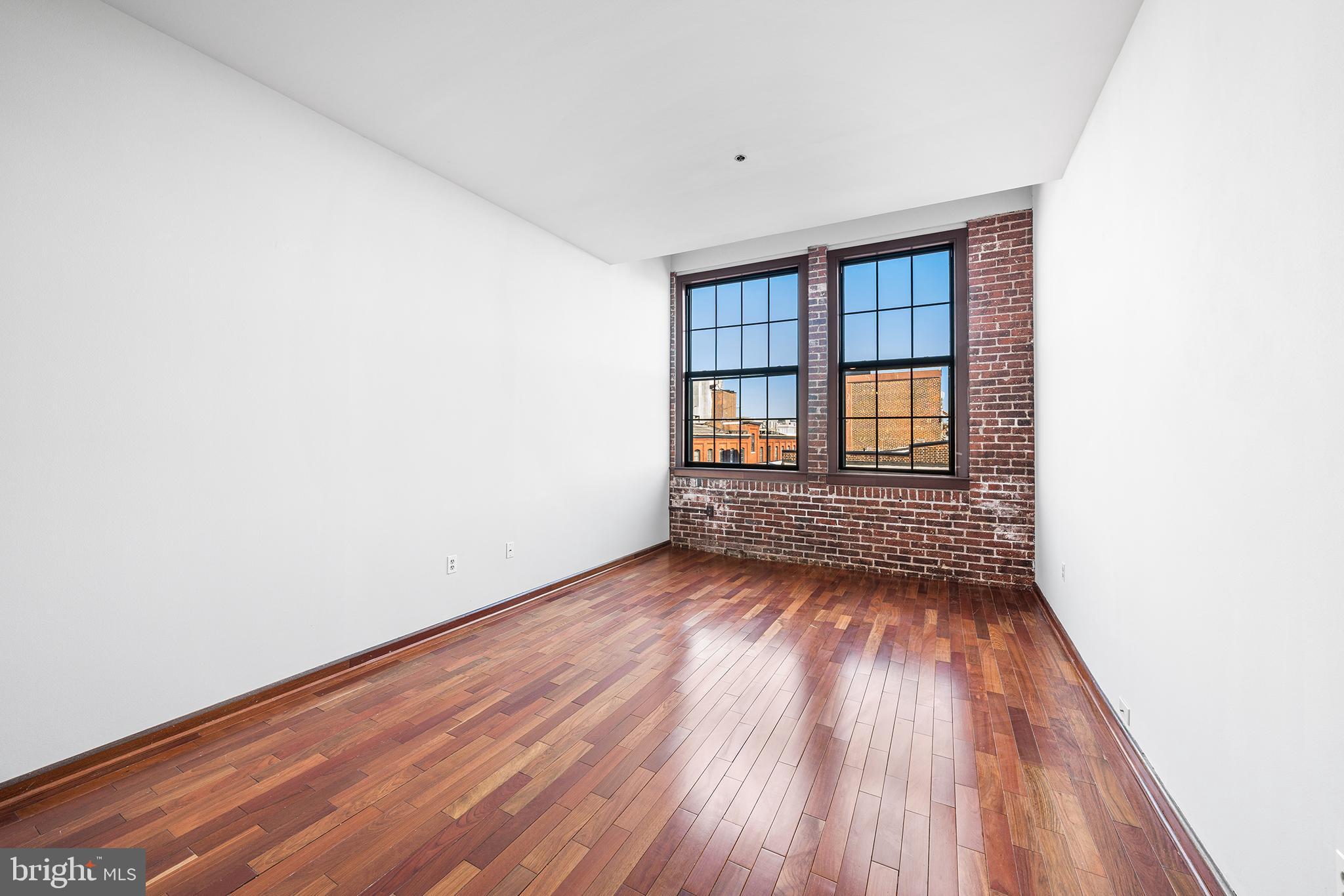 315 New Street, Unit 614 Philadelphia, PA 19106 - Photo 16 of 34 Living room w/ exposed brick and oversized windows
