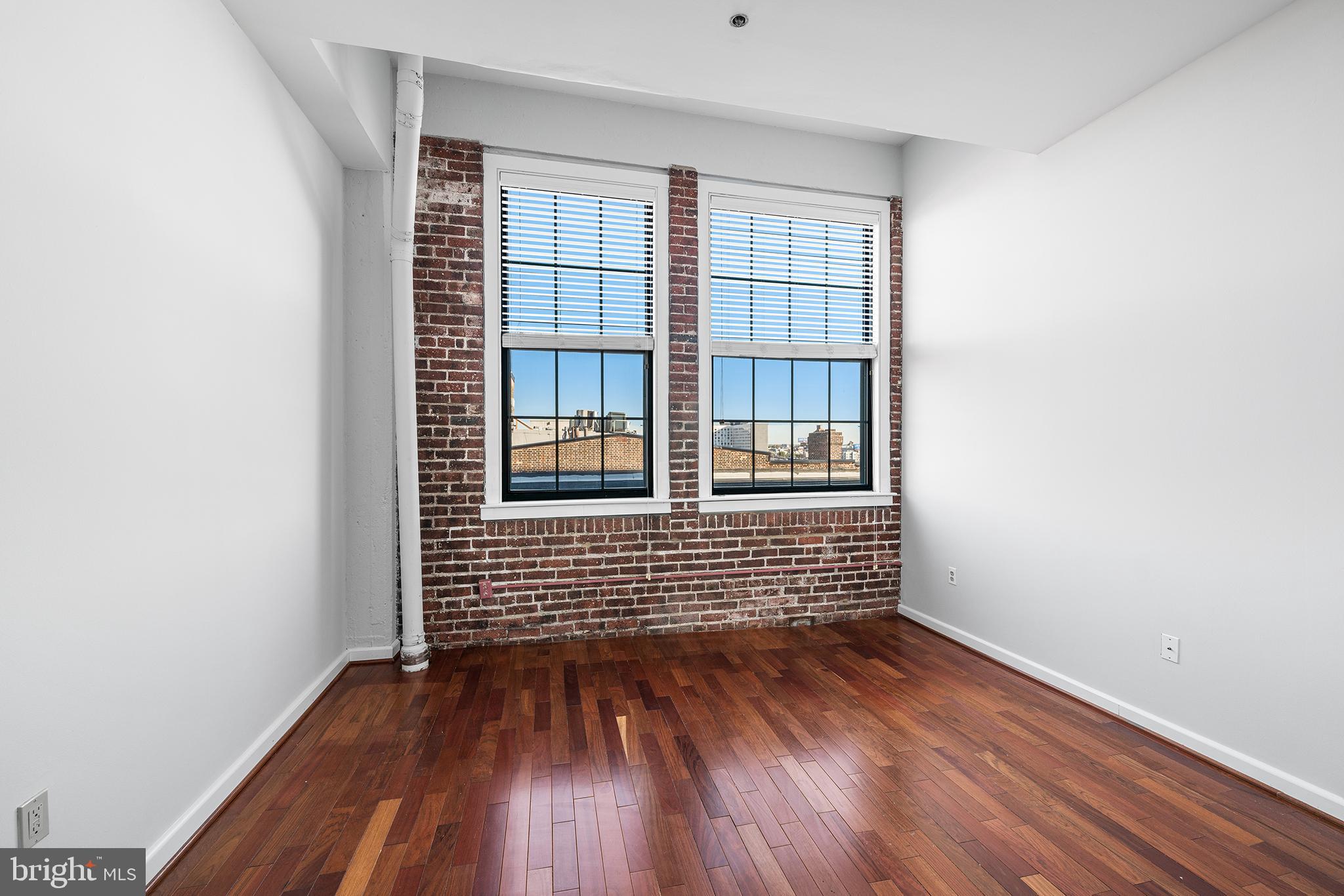 315 New Street, Unit 614 Philadelphia, PA 19106 - Photo 22 of 32 an empty room with wooden floor and windows