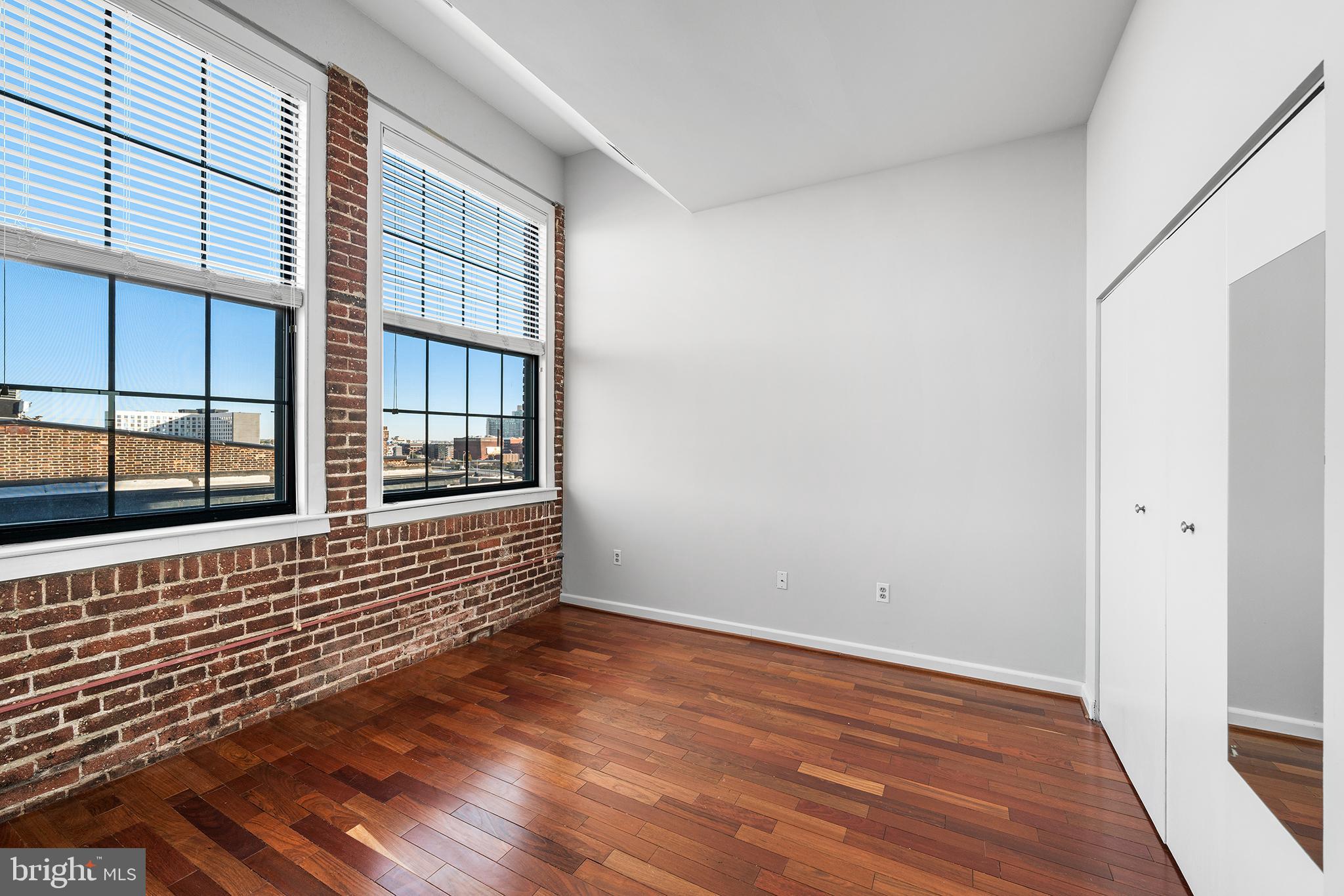 315 New Street, Unit 614 Philadelphia, PA 19106 - Photo 23 of 32 an empty room with wooden floor and windows