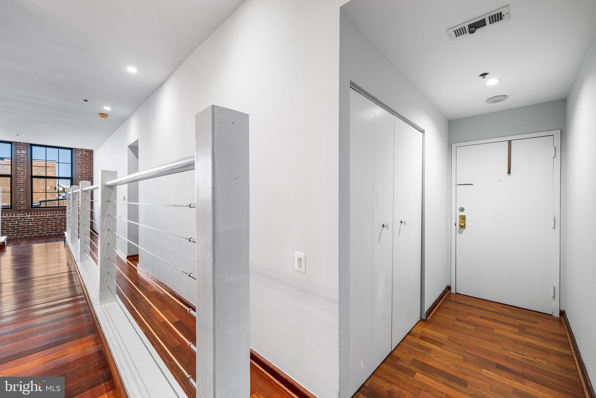 315 New Street, Unit 614 Philadelphia, PA 19106 - Photo 4 of 32 a view of hallway with stairs and wooden floor