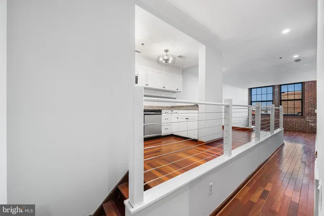 a view of kitchen with sink and wooden floor