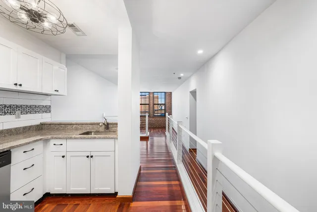 a kitchen with cabinets appliances and a counter space