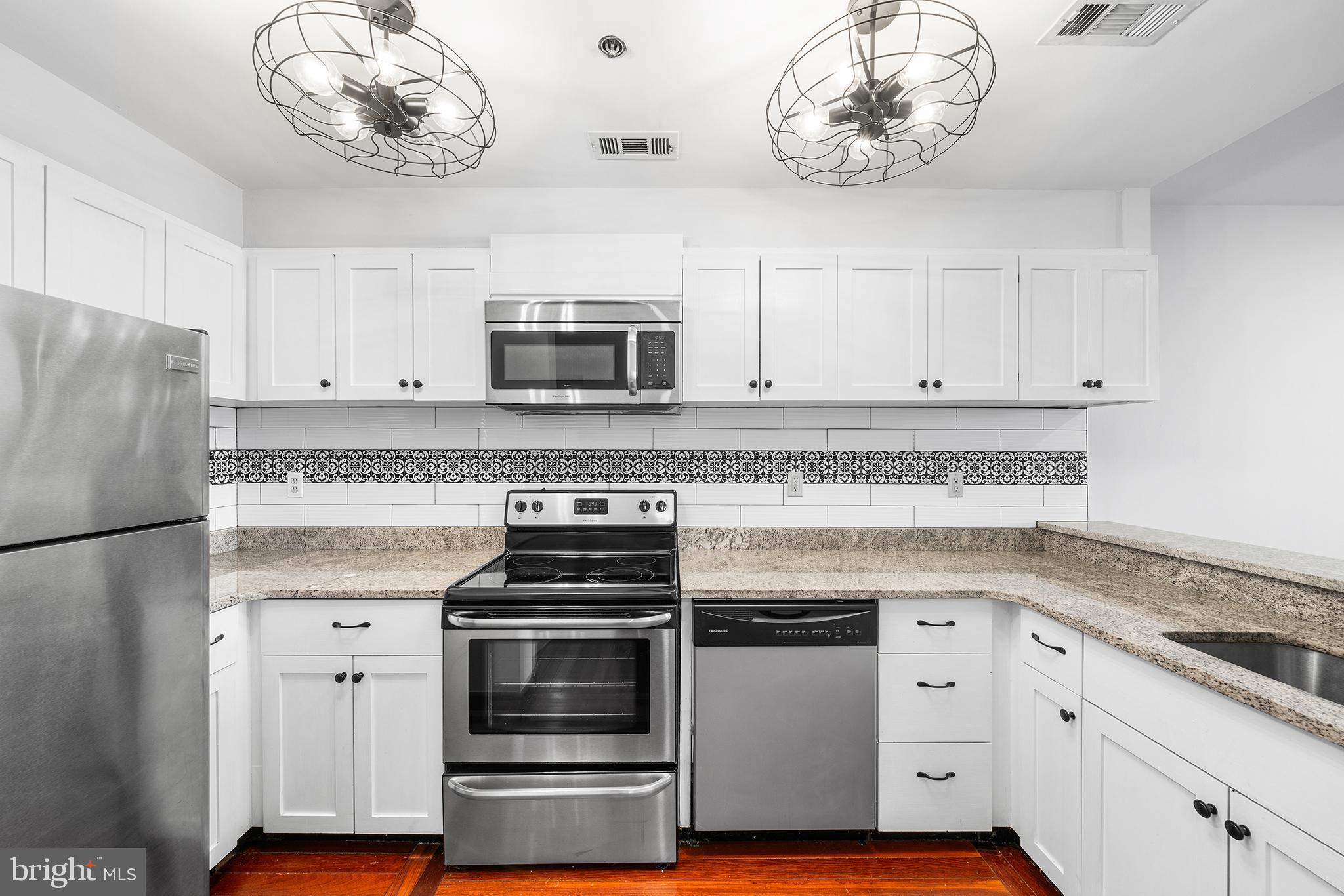 315 New Street, Unit 614 Philadelphia, PA 19106 - Photo 7 of 32 a kitchen with cabinets appliances and a counter space