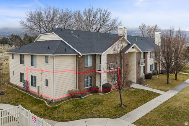 2095 South Main Street, Unit 13 Bountiful, UT 84010 - Photo 3 of 45 View of property exterior featuring brick siding, a yard, a shingled roof, and a chimney