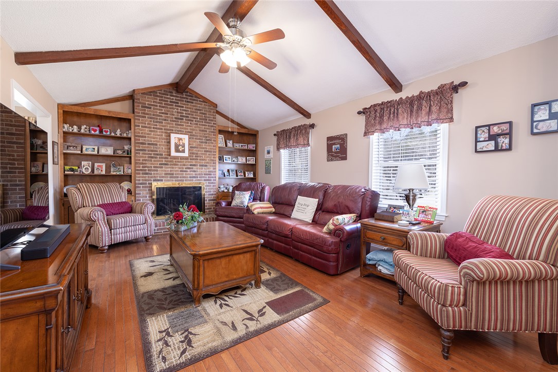 404 South Old Mill Road Seneca, SC 29678 - Photo 5 of 39 Exposed ceiling beams and a brick fireplace create a warm, inviting living space.