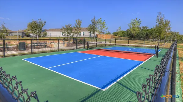a view of a patio with a table and chairs under an umbrella