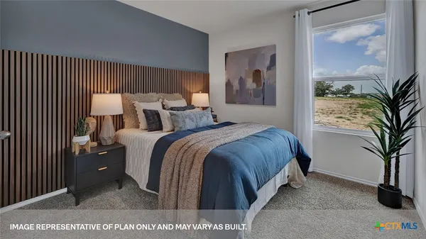 a bed room with a bed and a potted plant