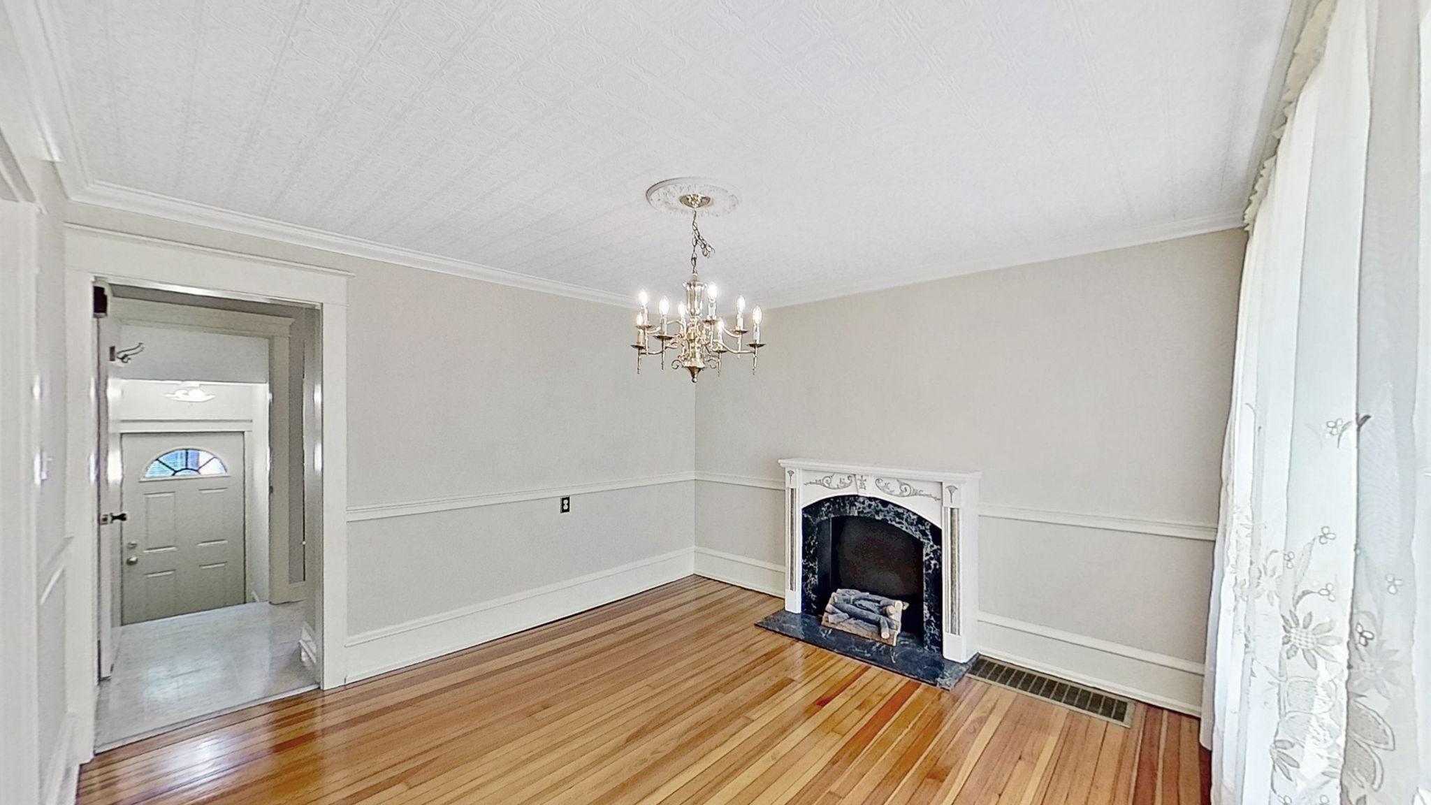 405 Union Street Milton, DE 19968 - Photo 18 of 83 a view of a livingroom with wooden floor a ceiling fan and a fireplace