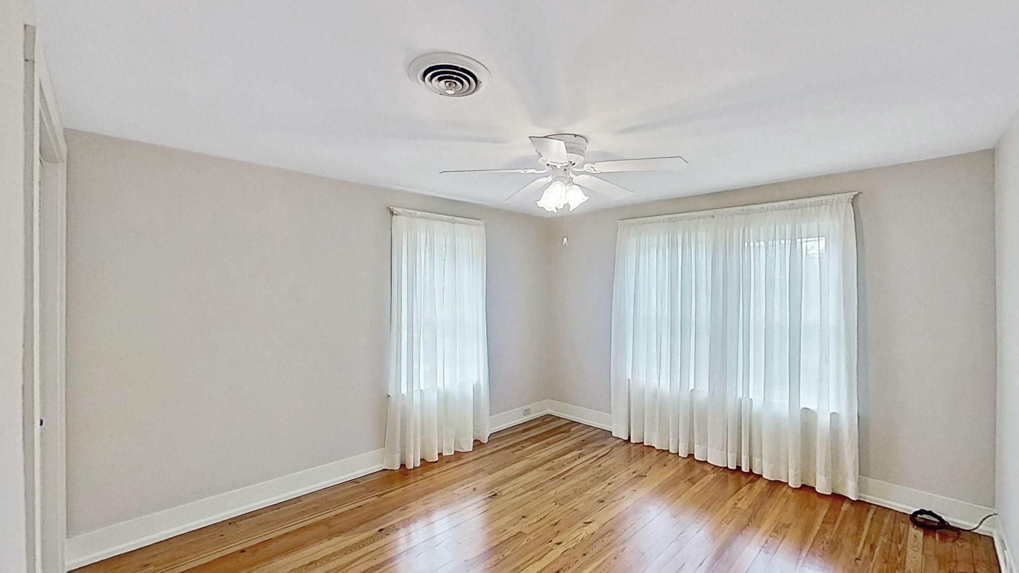 405 Union Street Milton, DE 19968 - Photo 40 of 83 an empty room with wooden floor fan and windows