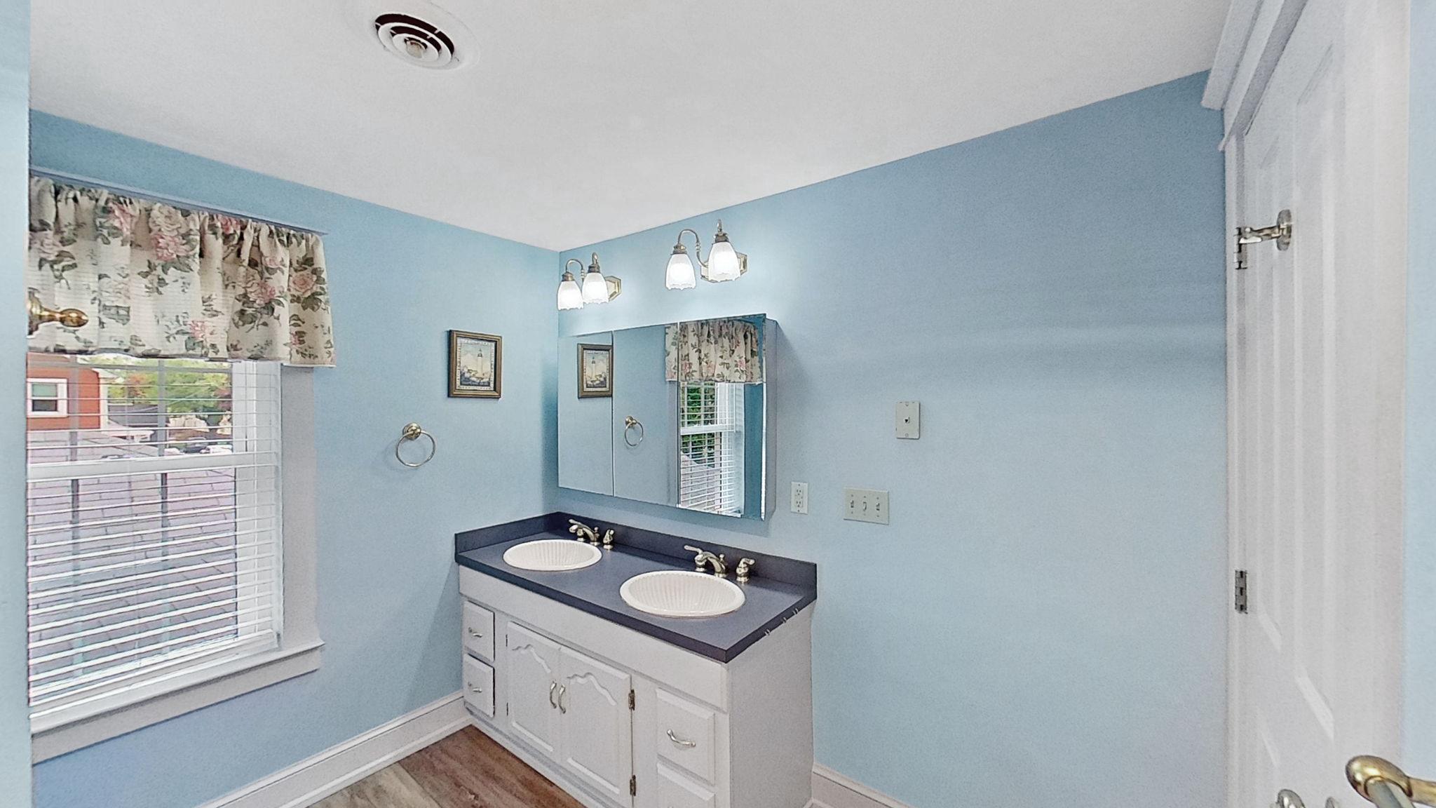 405 Union Street Milton, DE 19968 - Photo 45 of 83 a bathroom with a granite countertop sink a toilet and mirror