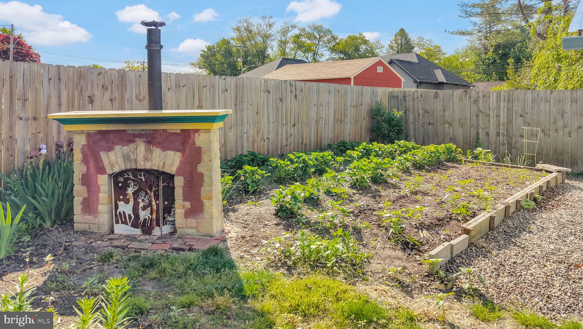 405 Union Street Milton, DE 19968 - Photo 66 of 83 Charming garden with a rustic oven.