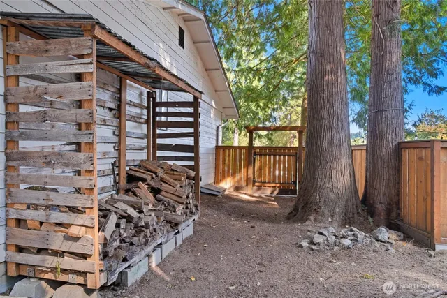 a view of a house with a door and wooden walls