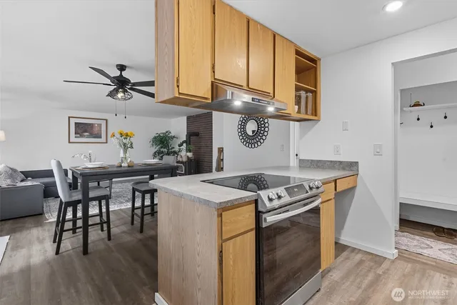 a kitchen with a stove a table and chairs