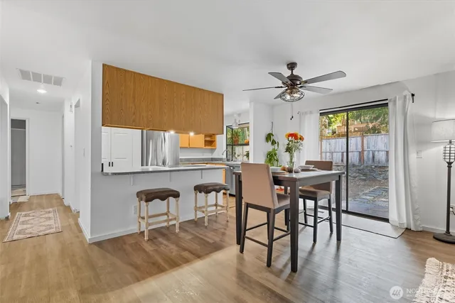 a view of a dining room with furniture window and wooden floor