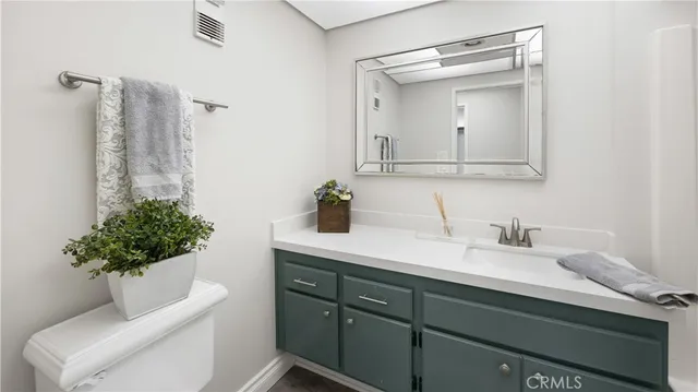a view of a living room and a book shelf