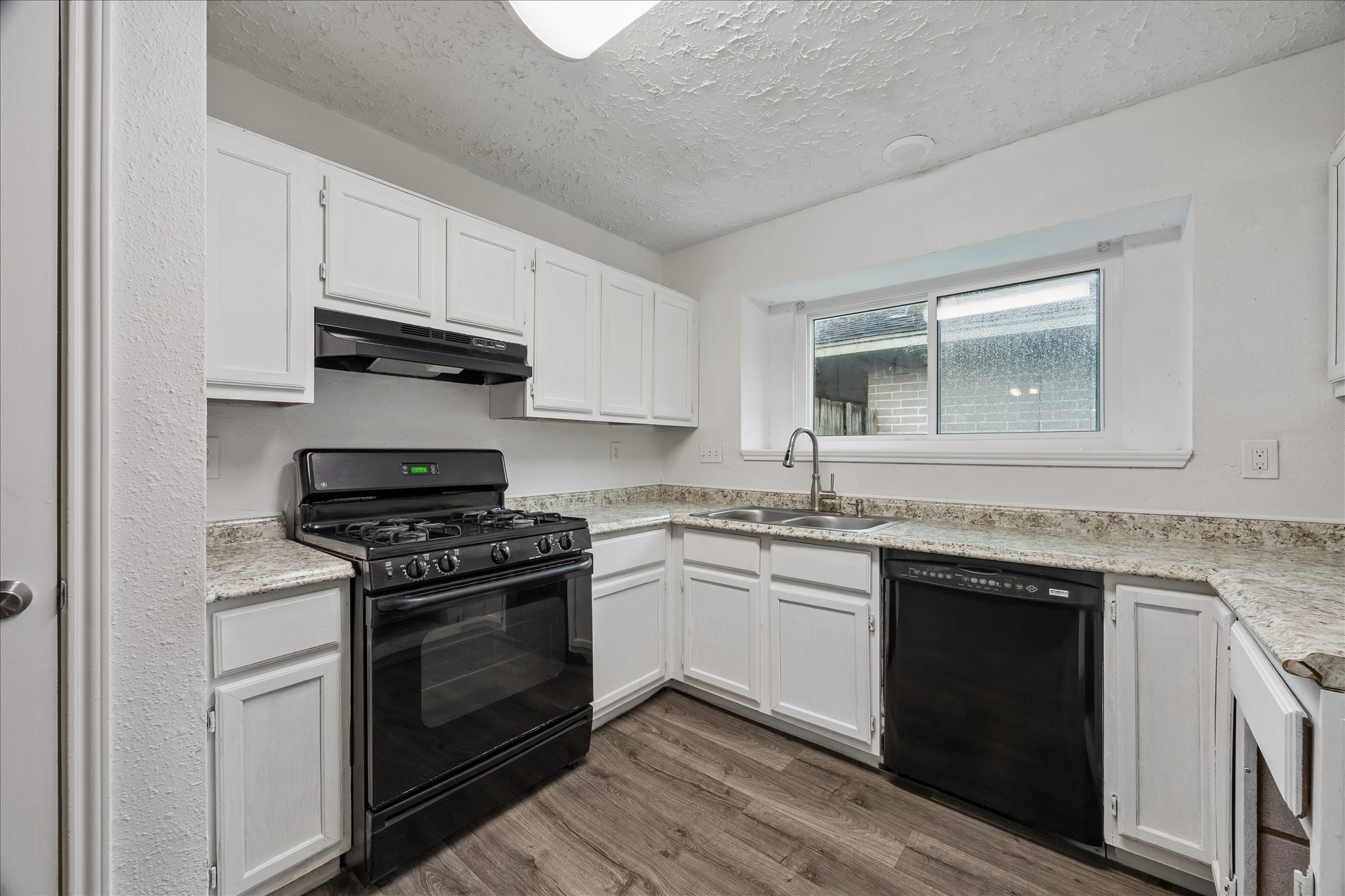 16715 Benchmark Drive Houston, TX 77053 - Photo 2 of 14 a kitchen with stainless steel appliances granite countertop a stove and a sink