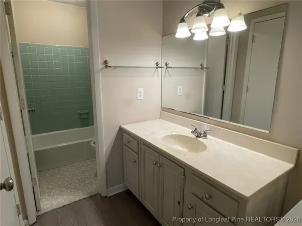 a bathroom with a sink tub and shower
