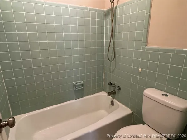 a bath tub sitting next to a white toilet