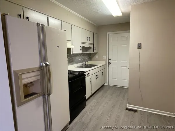 a kitchen with a refrigerator sink and stove