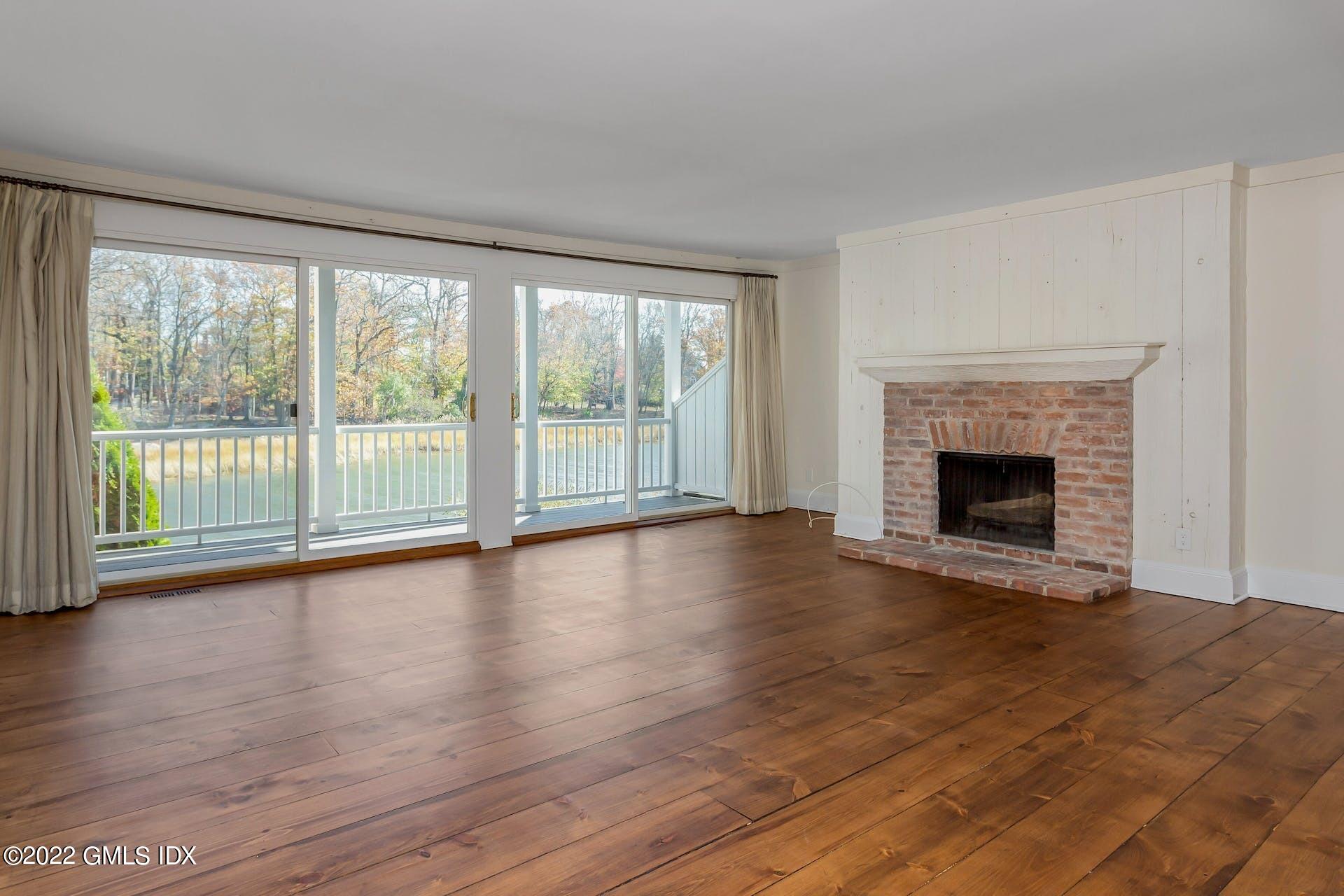 603 Steamboat Road, Unit 6 Greenwich, CT 06830 - Photo 11 of 40 a view of empty room with wooden floor and fireplace