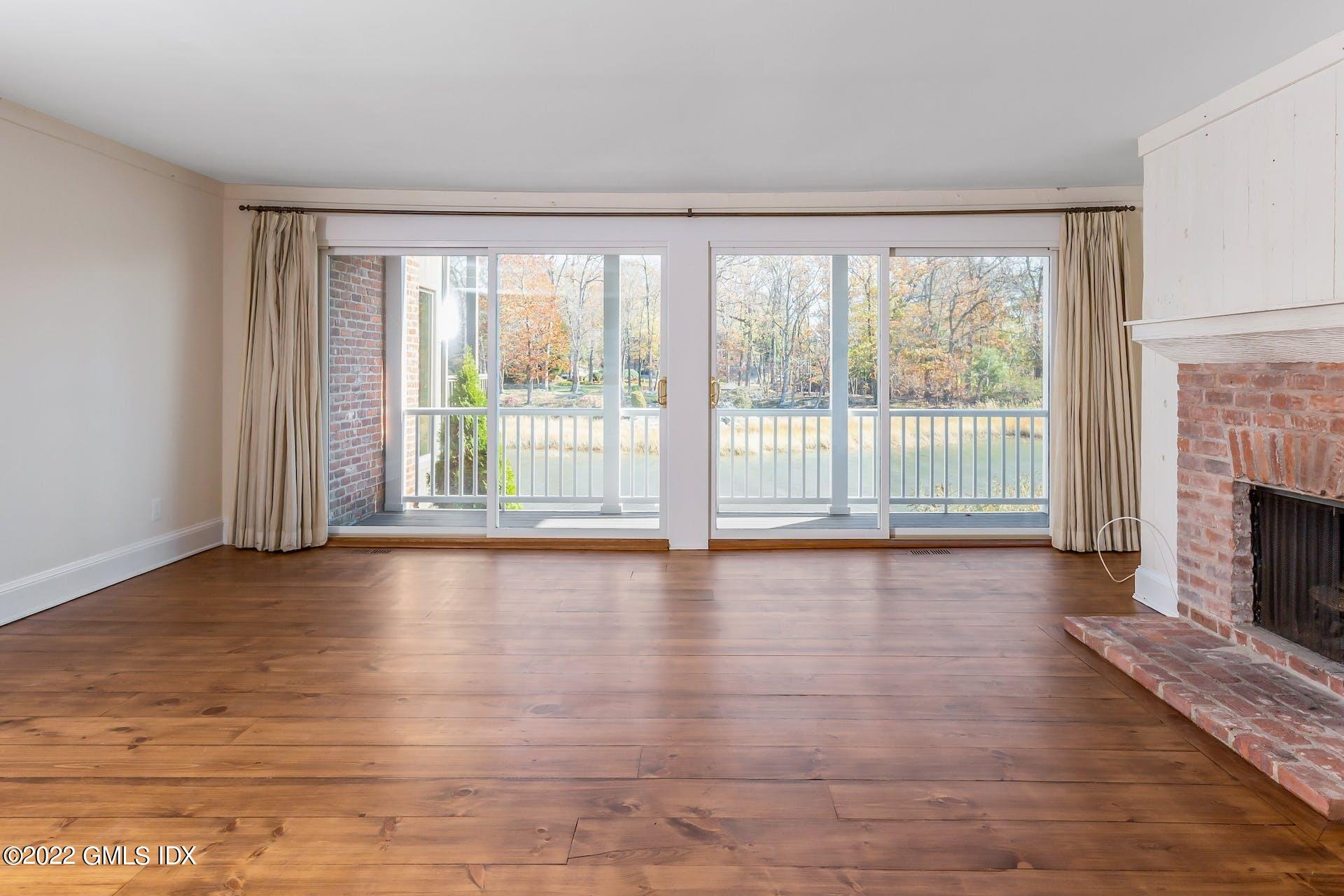 603 Steamboat Road, Unit 6 Greenwich, CT 06830 - Photo 13 of 40 a view of empty room with wooden floor and fireplace