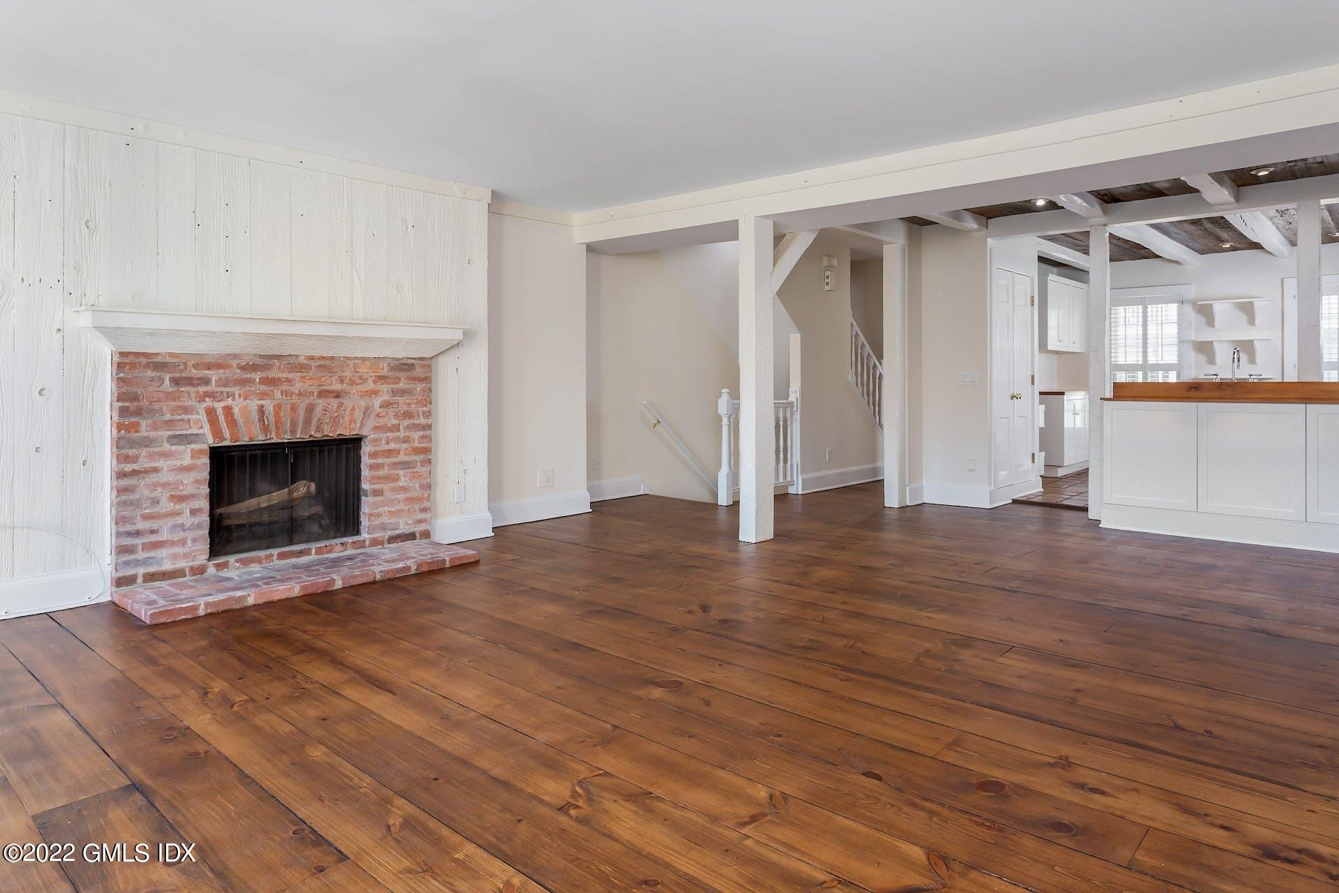 603 Steamboat Road, Unit 6 Greenwich, CT 06830 - Photo 14 of 40 a view of empty room with wooden floor and fireplace