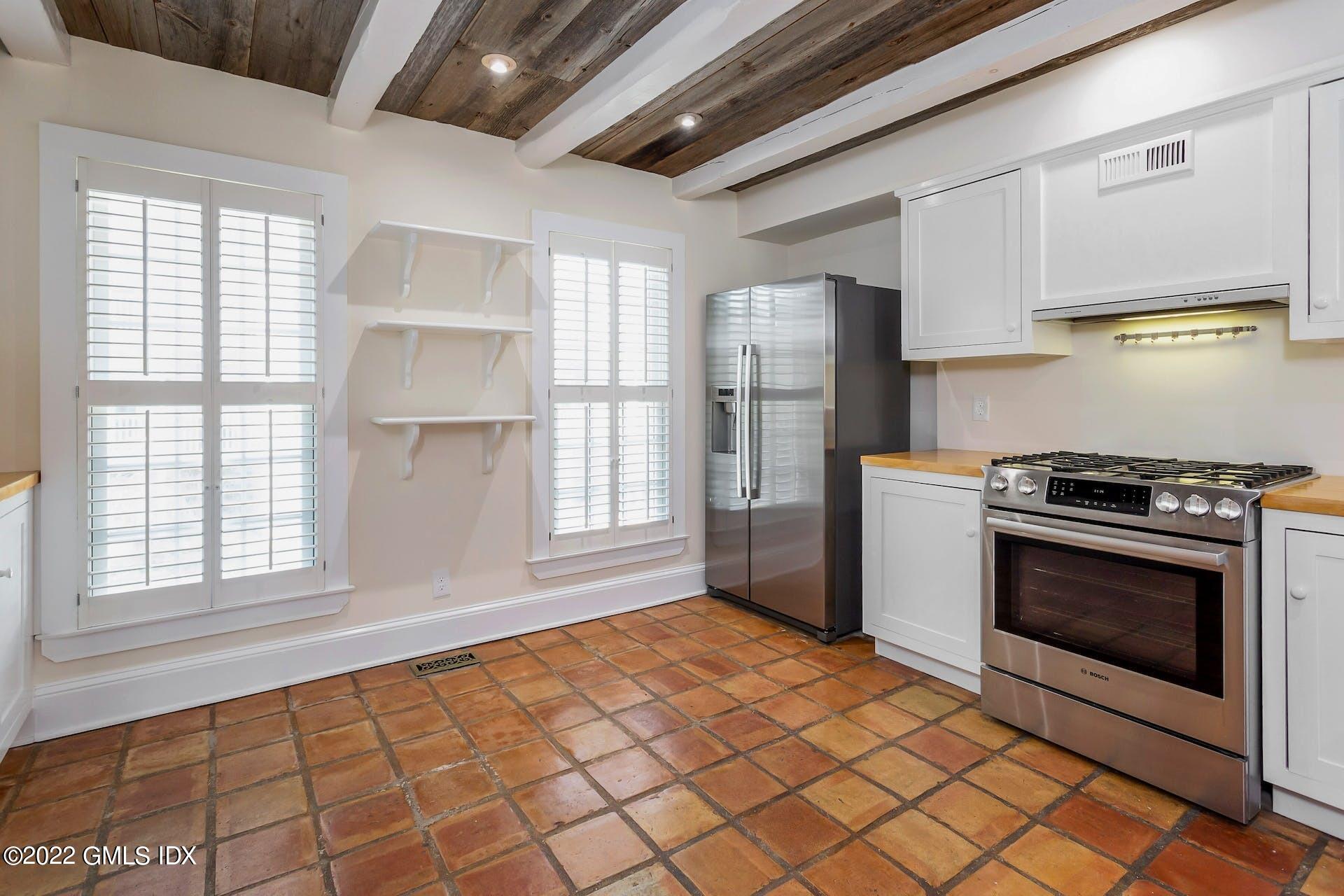 603 Steamboat Road, Unit 6 Greenwich, CT 06830 - Photo 15 of 40 a kitchen with stainless steel appliances a stove a sink and a refrigerator