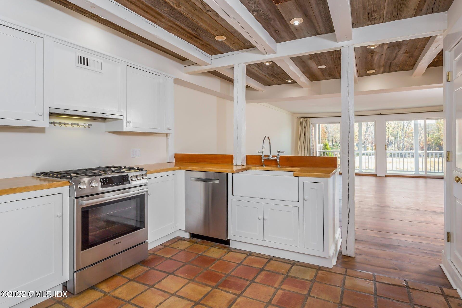 603 Steamboat Road, Unit 6 Greenwich, CT 06830 - Photo 16 of 40 a kitchen with a stove top oven and cabinets