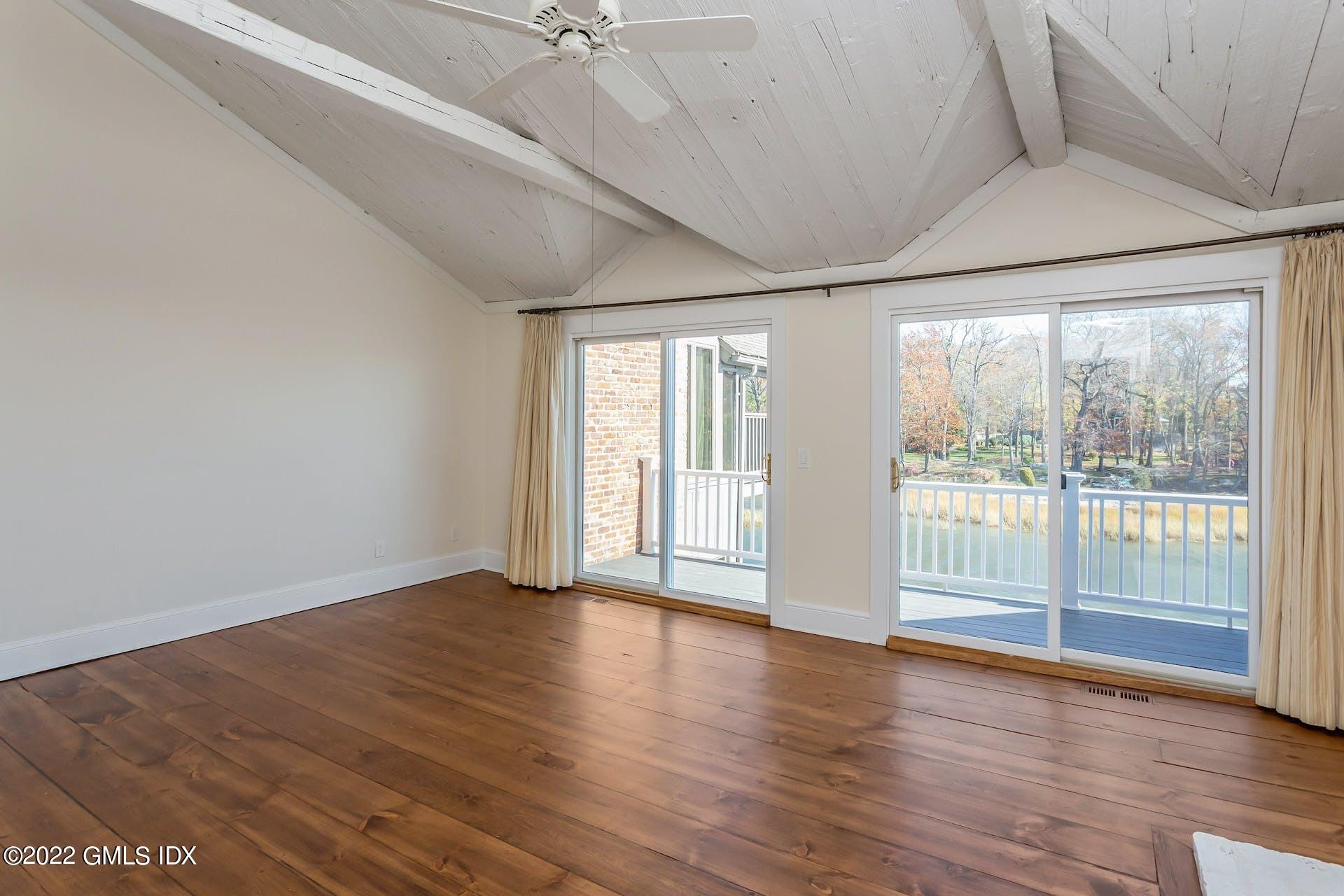 603 Steamboat Road, Unit 6 Greenwich, CT 06830 - Photo 19 of 40 a view of an empty room with wooden floor and a window