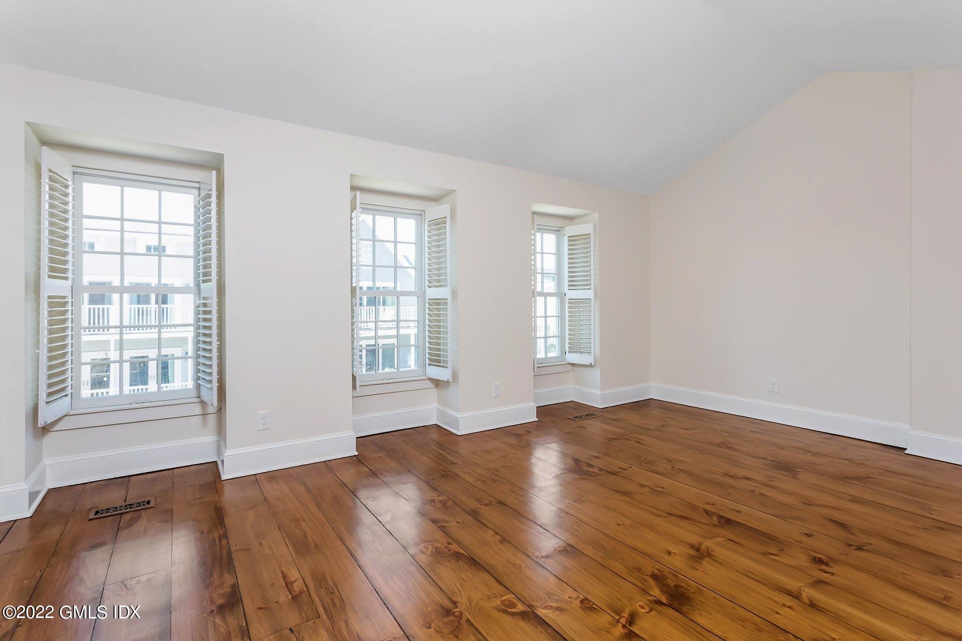 603 Steamboat Road, Unit 6 Greenwich, CT 06830 - Photo 25 of 40 an empty room with wooden floor and windows