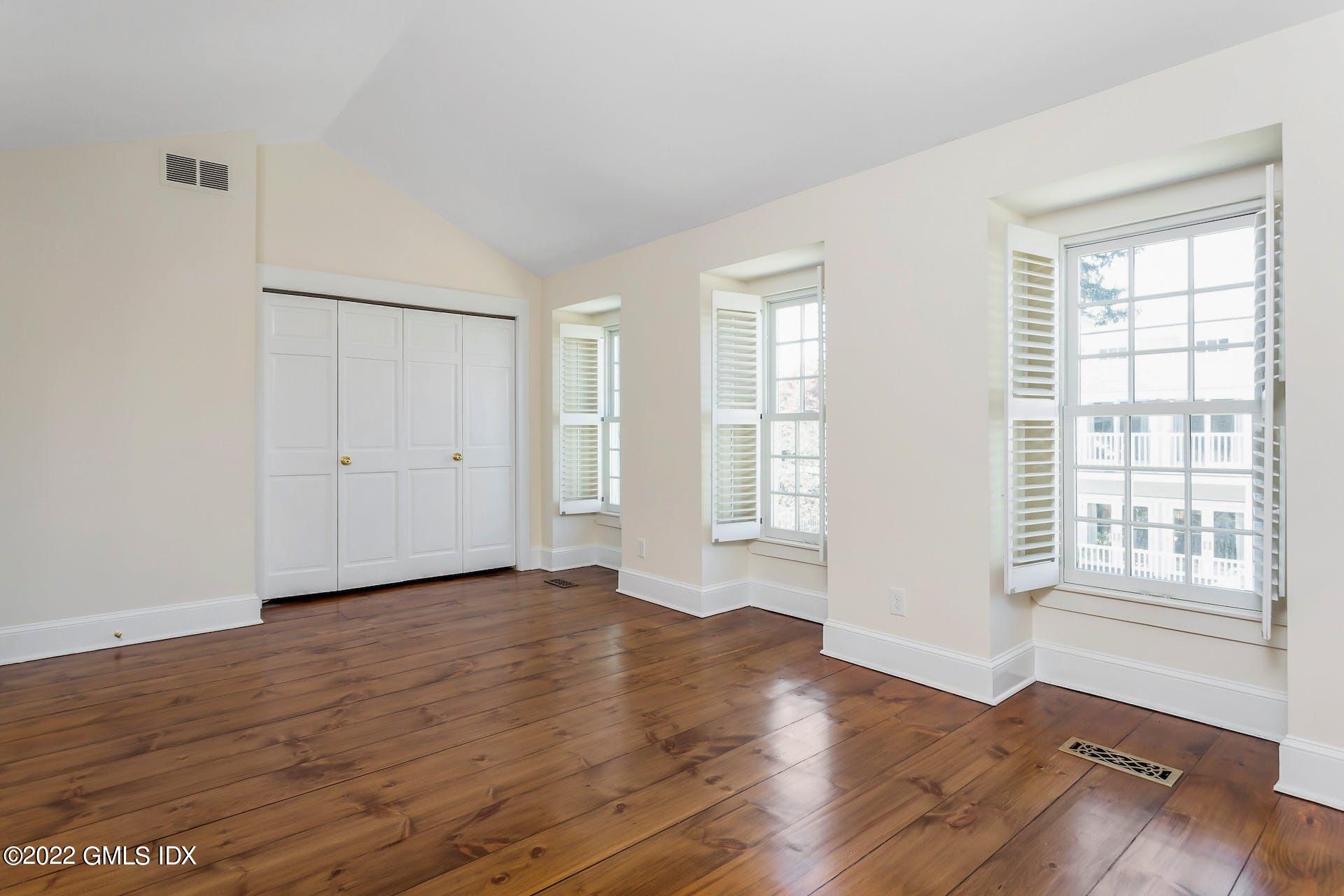 603 Steamboat Road, Unit 6 Greenwich, CT 06830 - Photo 27 of 40 an empty room with wooden floor and windows