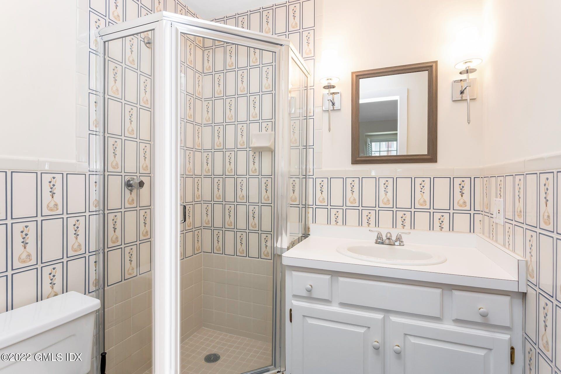 603 Steamboat Road, Unit 6 Greenwich, CT 06830 - Photo 28 of 40 a bathroom with a sink a toilet and shower