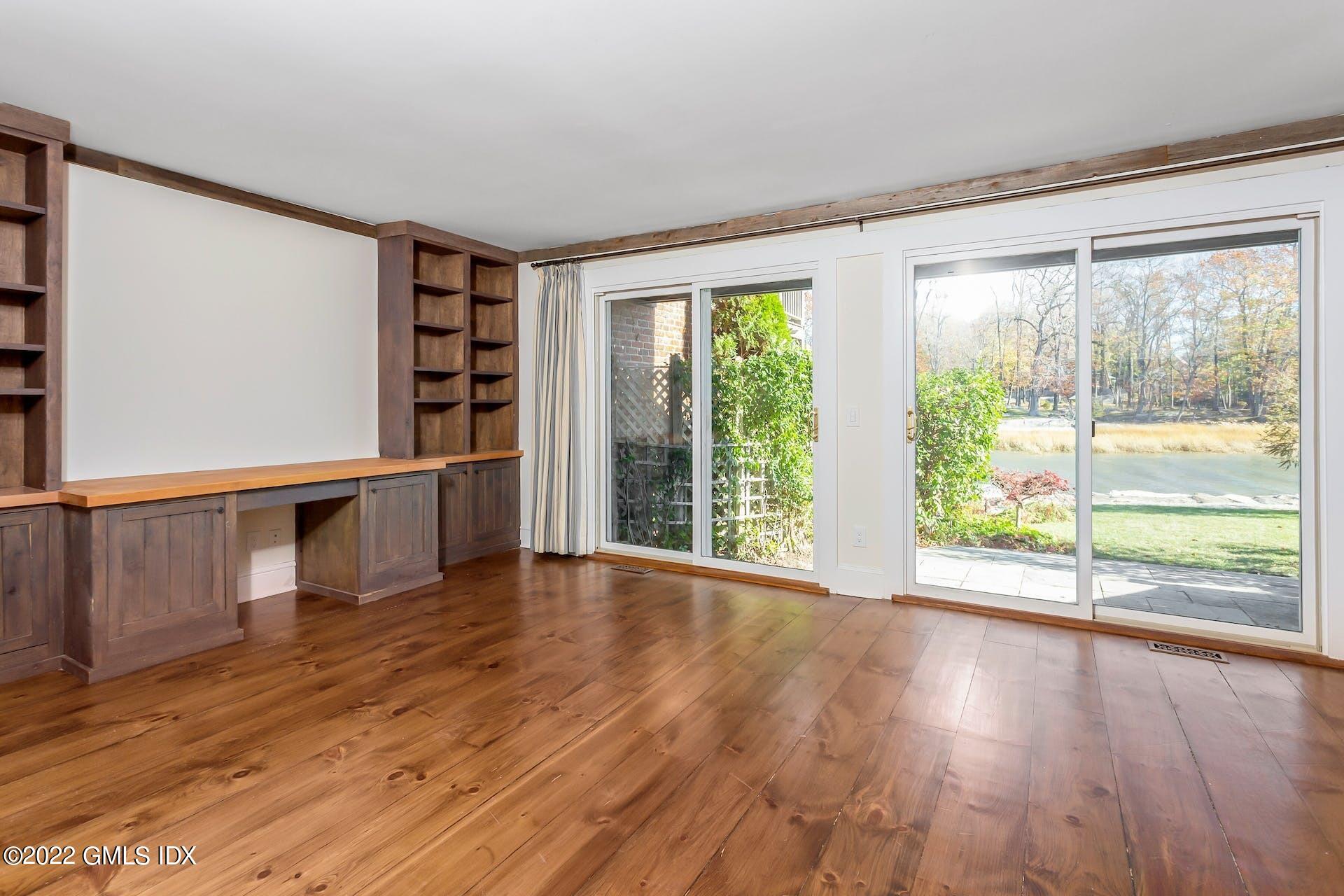603 Steamboat Road, Unit 6 Greenwich, CT 06830 - Photo 29 of 40 a view of an empty room with wooden floor and a window