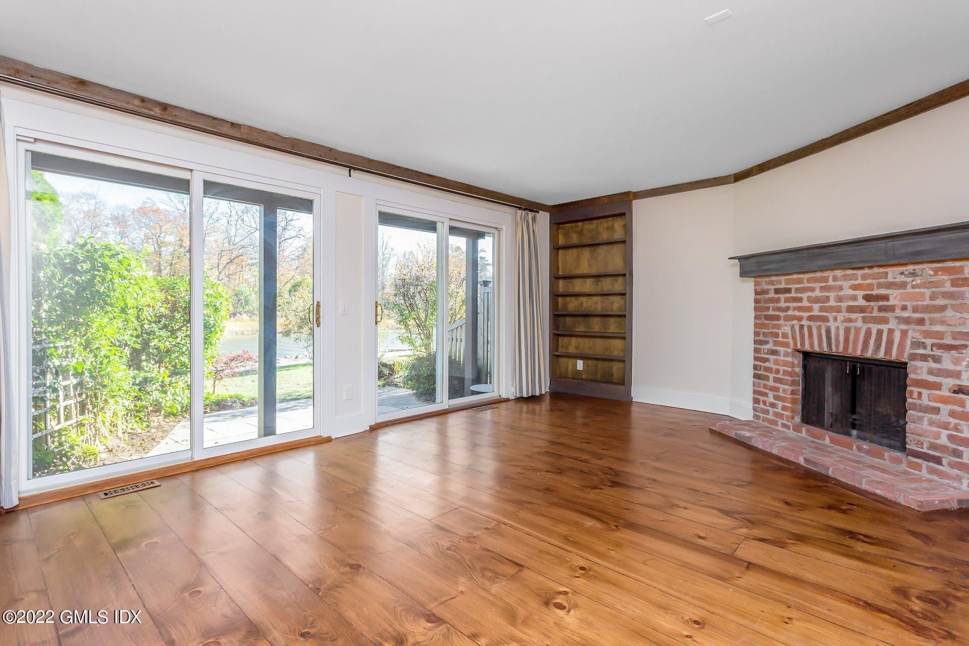 603 Steamboat Road, Unit 6 Greenwich, CT 06830 - Photo 31 of 40 a view of an empty room with wooden floor and a window